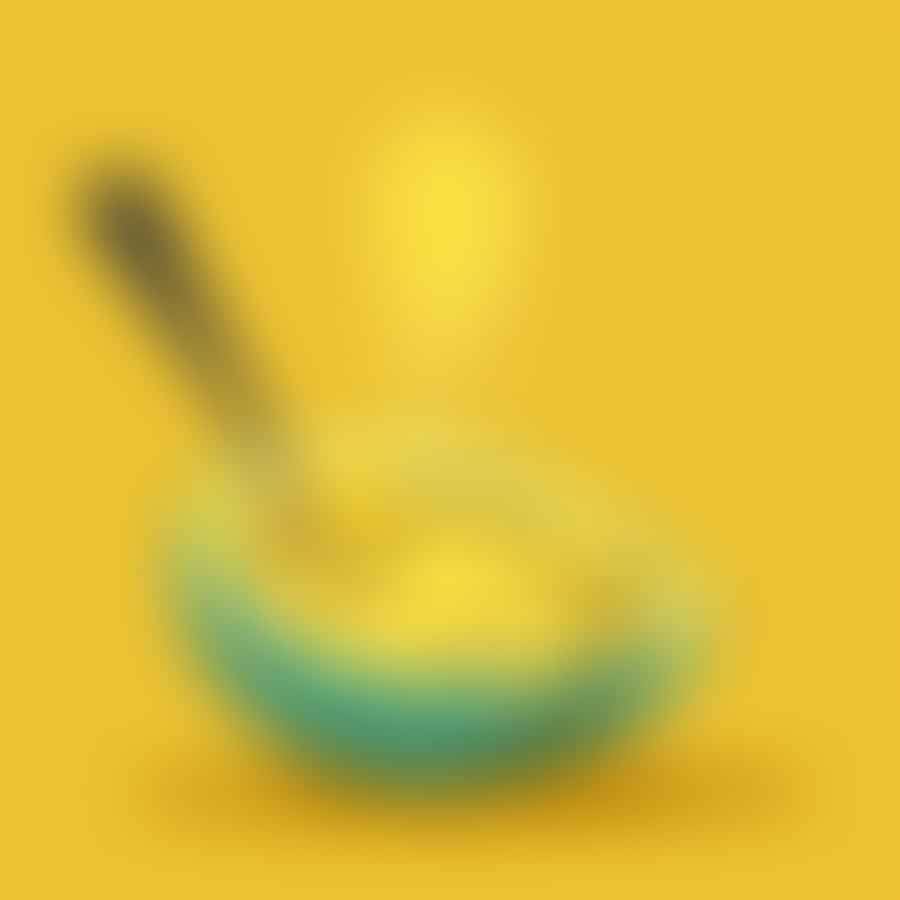 A spoon scooping seeds out of a spaghetti squash