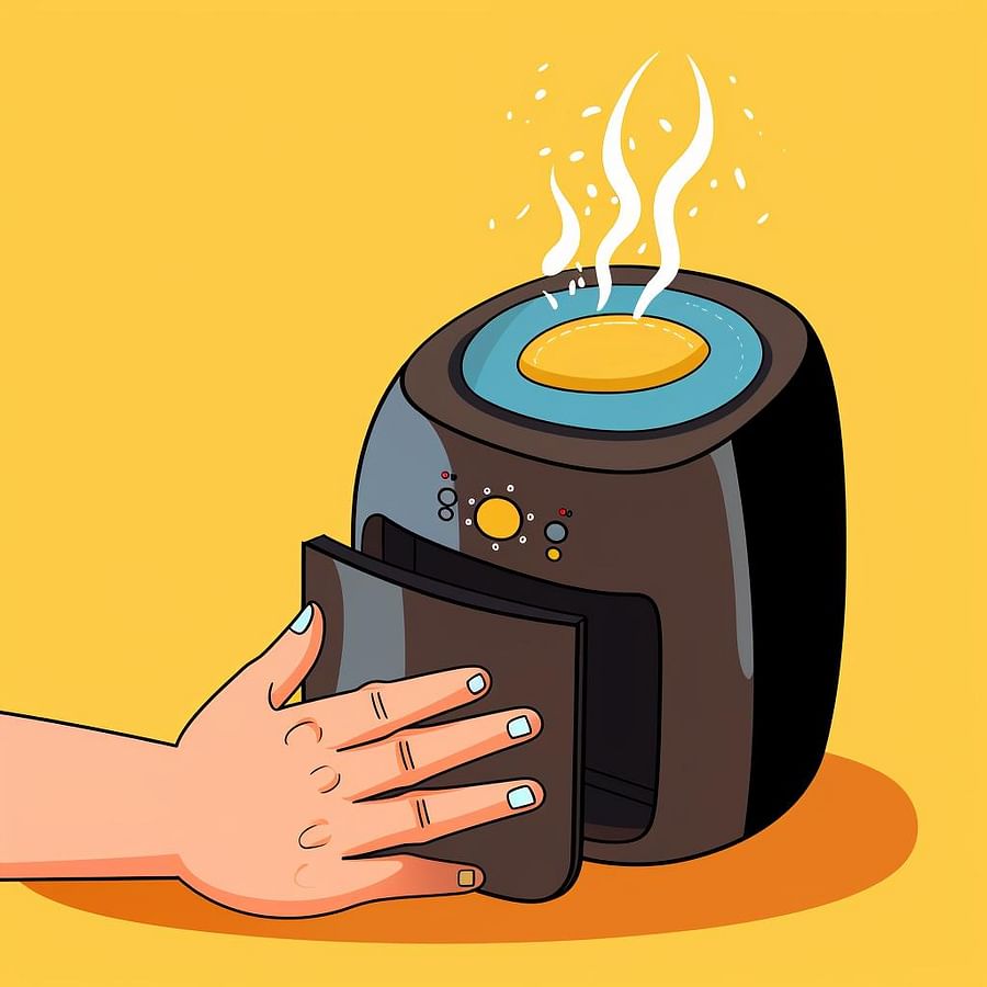 Hand wiping the interior of an air fryer with a damp cloth
